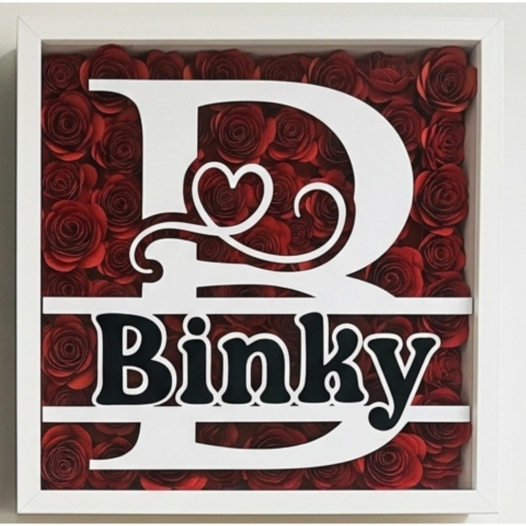 Black Shadowbox with initial and name surrounded by colorful hand rolled flowers